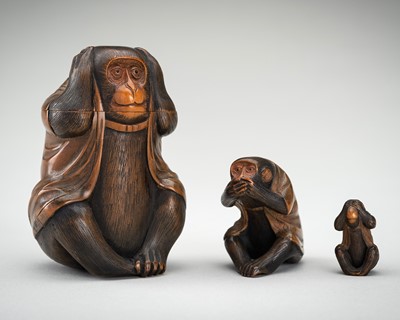 Lot 338 - KUNIMITSU: A WOOD TONKOTSU WITH MATCHING NETSUKE AND OJIME OF THE SAMBIKI SARU (THREE WISE MONKEYS)