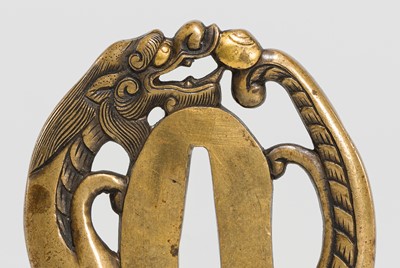 Lot 228 - A FINE YOSHIYUKI SCHOOL SENTOKU TSUBA IN THE FORM OF A DRAGON