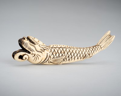 A STAG ANTLER SASHI NETSUKE OF A DRAGON FISH