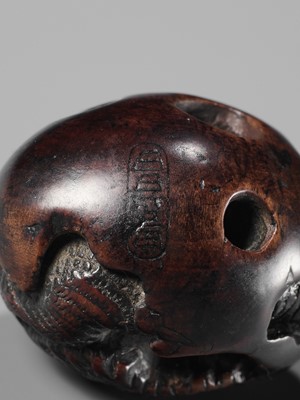 NAITO TOYOMASA: A FINE WOOD NETSUKE OF A DRAGON EMERGING FROM AN EGG