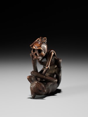 Lot 98 - A FINE WOOD NETSUKE OF A WOLF AND SKELETON, ATTRIBUTED TO SHOKO SUGONOYA