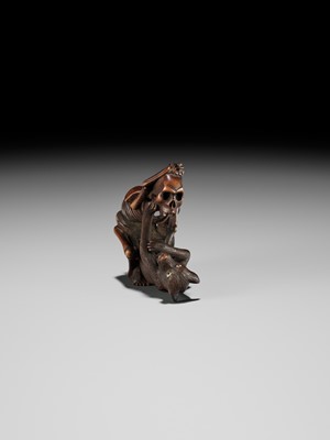 Lot 98 - A FINE WOOD NETSUKE OF A WOLF AND SKELETON, ATTRIBUTED TO SHOKO SUGONOYA