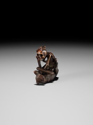 Lot 98 - A FINE WOOD NETSUKE OF A WOLF AND SKELETON, ATTRIBUTED TO SHOKO SUGONOYA