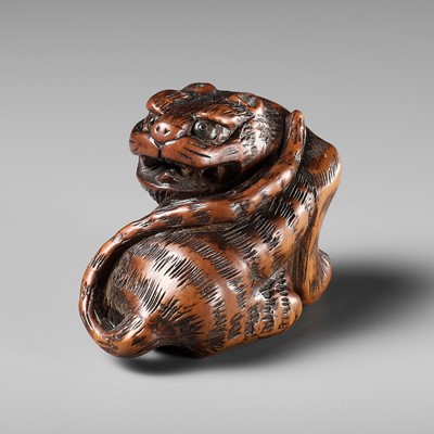 Lot 457 - MINKO: A POWERFUL WOOD NETSUKE OF A TIGER