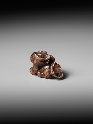 Lot 457 - MINKO: A POWERFUL WOOD NETSUKE OF A TIGER