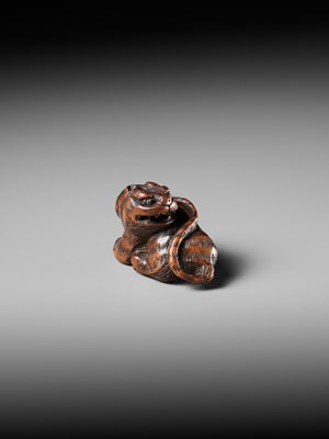 Lot 457 - MINKO: A POWERFUL WOOD NETSUKE OF A TIGER