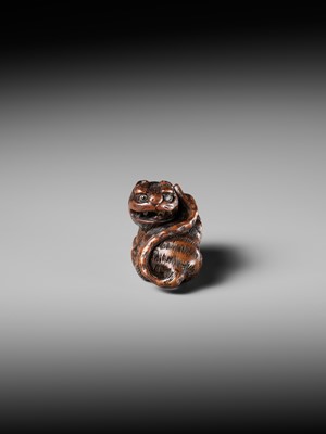 Lot 457 - MINKO: A POWERFUL WOOD NETSUKE OF A TIGER