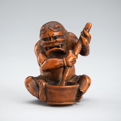 GYOKUMIN: A WOOD NETSUKE OF ONI MAKING MOCHI