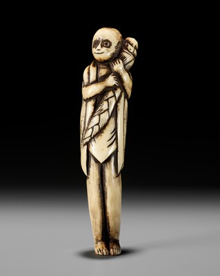 AN ANTLER NETSUKE OF A MONKEY HOLDING A BAMBOO SHOOT