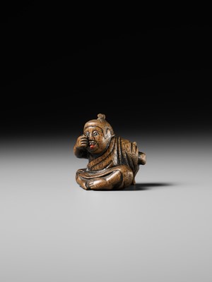 Lot 437 - MIWA: A WOOD NETSUKE OF A BOY HIDING A HANYA MASK