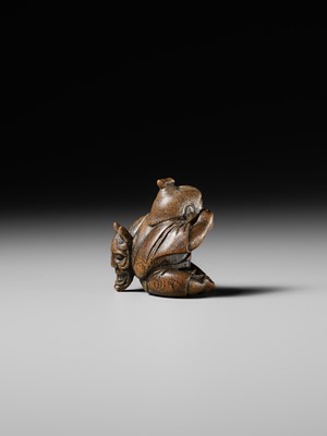 Lot 437 - MIWA: A WOOD NETSUKE OF A BOY HIDING A HANYA MASK