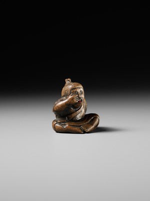 Lot 437 - MIWA: A WOOD NETSUKE OF A BOY HIDING A HANYA MASK