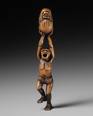 Lot 146 - A POWERFUL WOOD NETSUKE OF A DANCING MAN WITH A DARUMA DOLL