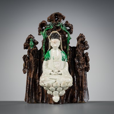 A FAMILLE VERTE BISCUIT FIGURE OF GUANYIN IN A GROTTO, KANGXI PERIOD