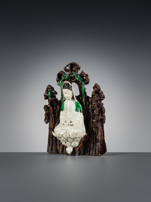 A FAMILLE VERTE BISCUIT FIGURE OF GUANYIN IN A GROTTO, KANGXI PERIOD