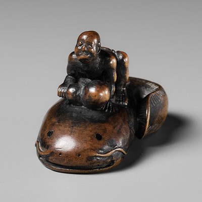 Lot 405 - NOBUKAZU: A RARE WOOD NETSUKE OF A BLIND FISHERMAN TAMING THE NAMAZU