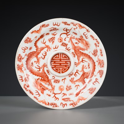 AN IRON-RED AND GILT ‘DRAGON’ SAUCER, JIAQING MARK AND POSSIBLY OF THE PERIOD
