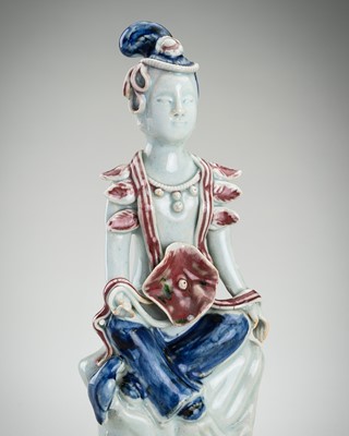 Lot 1925 - A COPPER RED AND UNDERGLAZE BLUE PAINTED FIGURE OF A FOREIGNER, LATE QING DYNASTY TO REPUBLIC PERIOD