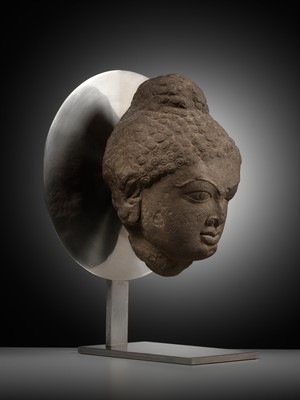 Lot 240 - A PINK SANDSTONE HEAD OF A JINA, 12TH CENTURY