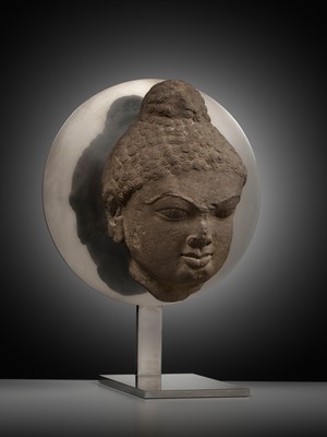 Lot 240 - A PINK SANDSTONE HEAD OF A JINA, 12TH CENTURY