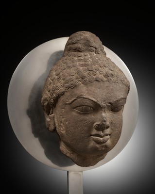 Lot 240 - A PINK SANDSTONE HEAD OF A JINA, 12TH CENTURY