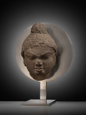 Lot 240 - A PINK SANDSTONE HEAD OF A JINA, 12TH CENTURY