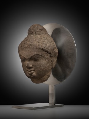 Lot 240 - A PINK SANDSTONE HEAD OF A JINA, 12TH CENTURY