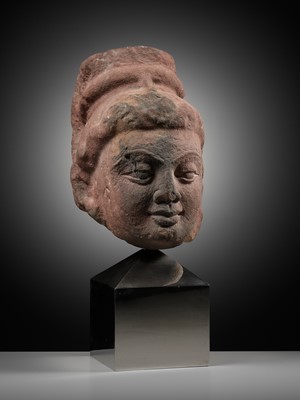 Lot 629 - A RARE MOTTLED RED SANDSTONE HEAD OF A YAKSHI, MATHURA