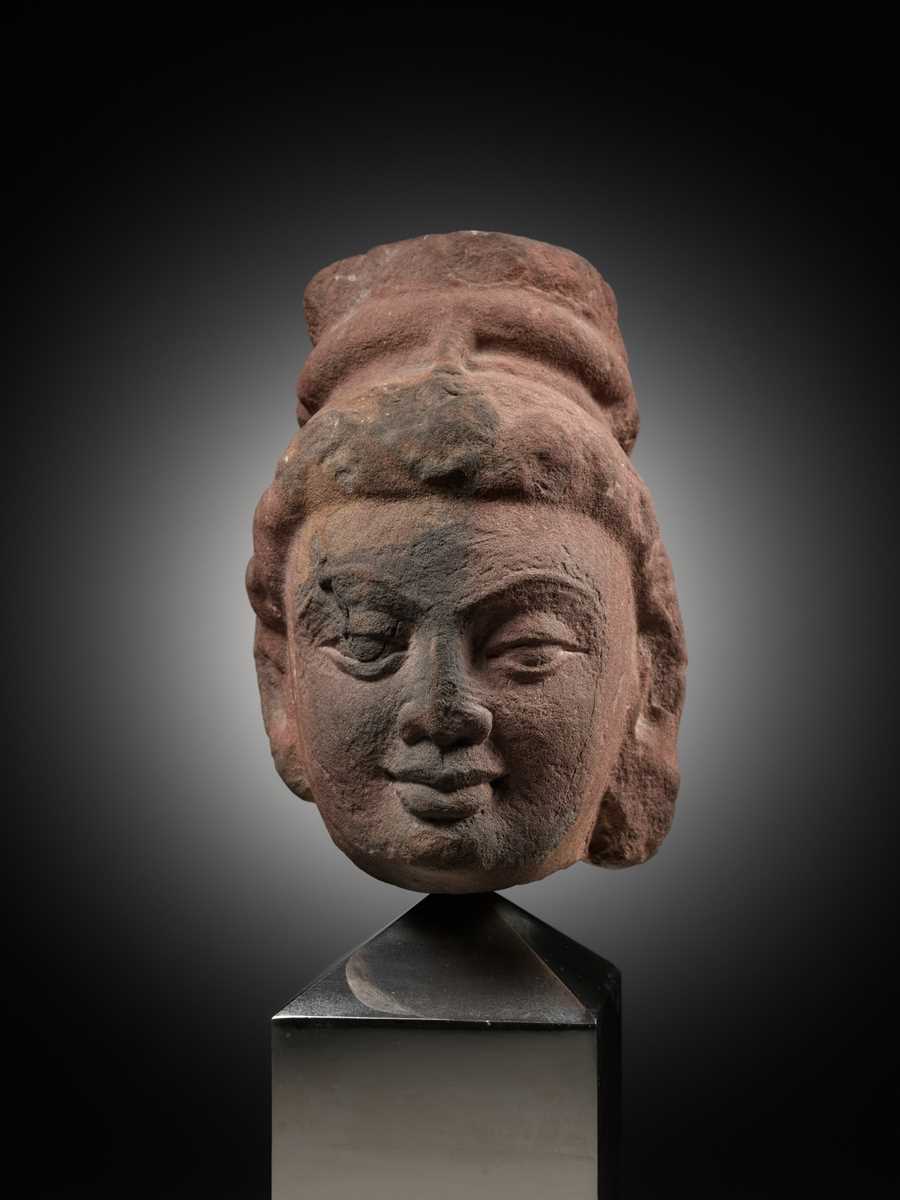 Lot 629 - A RARE MOTTLED RED SANDSTONE HEAD OF A