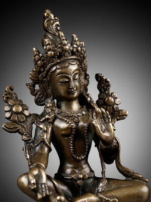 Lot 22 - A COPPER ALLOY FIGURE OF GREEN TARA, NEPAL, 18TH - 19TH CENTURY