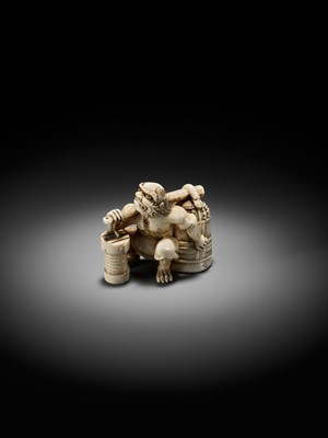 Lot 500 - RYOZAN: AN AMUSING IVORY NETSUKE OF AN ONI CARRYING A BONSHO AND CHOCHIN, CHOCHIN NI TSURIGANE