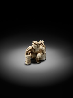 Lot 500 - RYOZAN: AN AMUSING IVORY NETSUKE OF AN ONI CARRYING A BONSHO AND CHOCHIN, CHOCHIN NI TSURIGANE