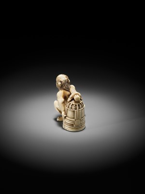 Lot 500 - RYOZAN: AN AMUSING IVORY NETSUKE OF AN ONI CARRYING A BONSHO AND CHOCHIN, CHOCHIN NI TSURIGANE