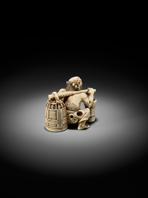 Lot 500 - RYOZAN: AN AMUSING IVORY NETSUKE OF AN ONI CARRYING A BONSHO AND CHOCHIN, CHOCHIN NI TSURIGANE