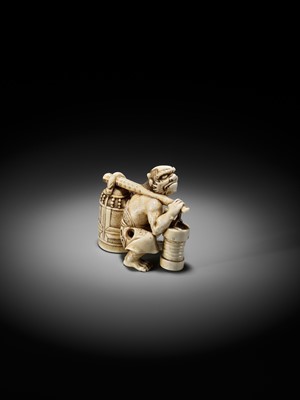 Lot 500 - RYOZAN: AN AMUSING IVORY NETSUKE OF AN ONI CARRYING A BONSHO AND CHOCHIN, CHOCHIN NI TSURIGANE