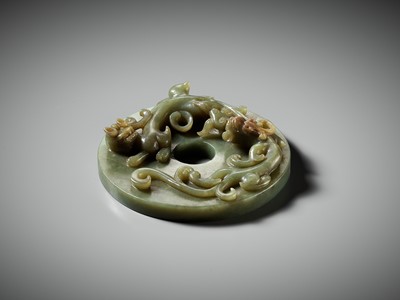 AN ARCHAISTIC GREEN AND RUSSET JADE ‘CHILONG WITH LINGZHI’ BI DISK, MING DYNASTY