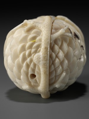 Lot 76 - KAIGYOKU MASATSUGU: A FINE IVORY NETSUKE OF JO AND UBA INSIDE A PINECONE