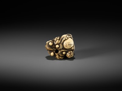 Lot 48 - GYOKUZAN: AN IVORY NETSUKE OF A SHISHI