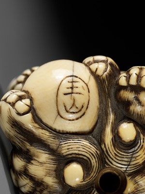 Lot 48 - GYOKUZAN: AN IVORY NETSUKE OF A SHISHI