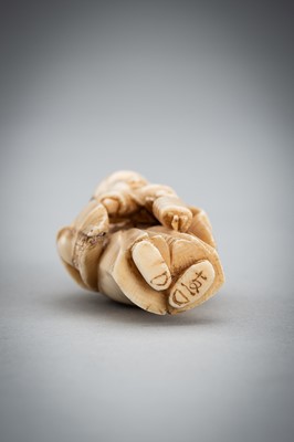 Lot 587 - TOMOKAZU: A FINE IVORY NETSUKE OF FUKUSUKE INSPECTING A NETSUKE ATTACHED TO AN INRO