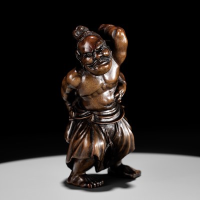 Lot 539 - A FINE WOOD NETSUKE OF NIO CARRYING AN UPSIDE-DOWN ONI