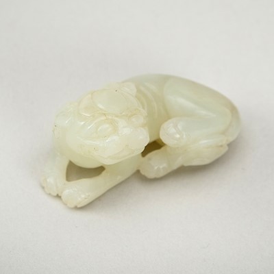 Lot 1827 - A PALE CELADON JADE ‘BUDDHIST LION’ PENDANT, c. 1900s