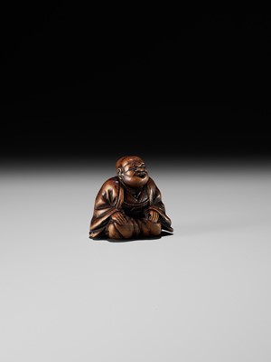 FUJI: A WOOD NETSUKE OF A RAKUGOKA, STORYTELLER