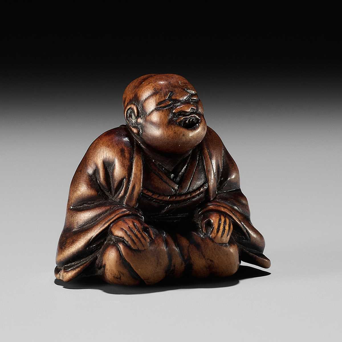 FUJI: A WOOD NETSUKE OF A RAKUGOKA, STORYTELLER