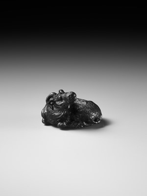 TATEKAWA KOSAI: AN EBONY WOOD NETSUKE OF A RECUMBENT OX