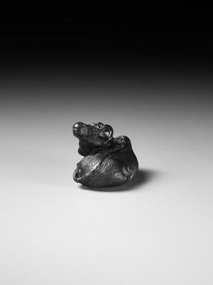 TATEKAWA KOSAI: AN EBONY WOOD NETSUKE OF A RECUMBENT OX