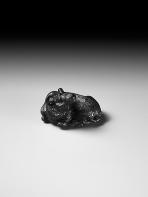 TATEKAWA KOSAI: AN EBONY WOOD NETSUKE OF A RECUMBENT OX