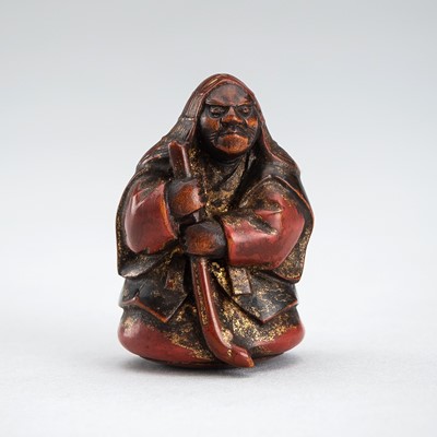 A RARE NEGORO LACQUER NETSUKE OF A HUNTER