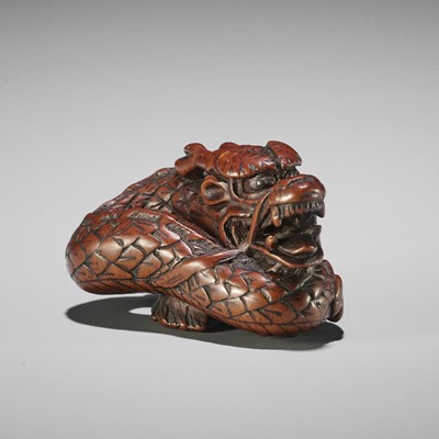 Lot 411 - A WOOD NETSUKE OF A COILED DRAGON