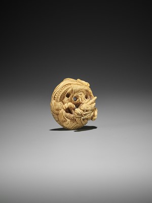 Lot 14 - AN IVORY NETSUKE OF A COILED ONE-HORNED DRAGON